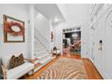 Elegant foyer with hardwood floors, staircase, and seating area, offering a warm welcome at 2602 Vintage Hill Ct, Durham, NC 27712