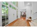 Bright foyer with hardwood floors, a double-door entrance, and views into the home office at 2602 Vintage Hill Ct, Durham, NC 27712