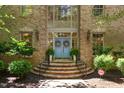 Inviting front entrance featuring brick steps, a blue double-door entrance, and well-manicured landscaping at 2602 Vintage Hill Ct, Durham, NC 27712