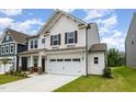Charming two-story home with stone accents, a well-manicured lawn, and a two-car garage at 27 Silver Moon Ln, Clayton, NC 27527