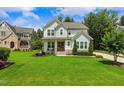Beautiful two-story home with a lush green lawn and a well-manicured landscape at 2716 Willow Rock Ln, Apex, NC 27523