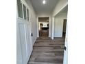 Inviting entryway with wood-look floors and white trim, leading into the home's interior at 290 Busterfield Ct, Benson, NC 27504