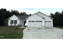 Charming single-story home with white siding, a spacious driveway, and a two-car garage at 295 Eason Creek Way, Clayton, NC 27527