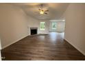 Inviting living room featuring a modern fireplace, large windows, and hardwood-style flooring at 295 Eason Creek Way, Clayton, NC 27527
