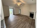 Bright living room featuring vaulted ceilings, a ceiling fan, luxury vinyl flooring, and a modern fireplace at 295 Eason Creek Way, Clayton, NC 27527
