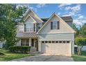Charming two-story home with a well-manicured lawn, two car garage, and craftsman style details at 3036 Landing Falls Ln, Raleigh, NC 27616