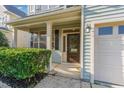 Inviting front porch with classic columns and a dark wood front door with sidelights and sidelight window at 3036 Landing Falls Ln, Raleigh, NC 27616