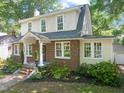 View of home's side and front with brickwork, gabled roof and many windows at 304 Polk St, Raleigh, NC 27604