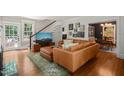 Bright living room with hardwood floors, staircase, and cozy seating area at 304 Polk St, Raleigh, NC 27604