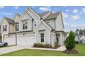 Charming two-story townhome with attached two-car garage, and well-manicured lawn at 3194 Retama Run, New Hill, NC 27562