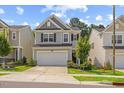 Charming two-story home featuring gray siding, black shutters, and a well-manicured lawn and landscaping at 3224 Star Gazing Ln, Durham, NC 27703