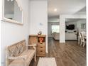 Entryway features a bench, cabinet, wood floors, leading to the living room and dining area at 3292 Longpine Rd, Burlington, NC 27215