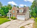 Charming home with stone accents, well maintained lawn, attached two-car garage and mature trees at 39 Westover Ct, Sanford, NC 27332