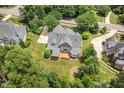 An overhead shot shows a home with a backyard deck, mature trees and professionally maintained lawn at 402 Bridewell Ct, Cary, NC 27518