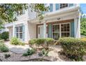 Inviting front porch with brick accents, stylish columns, manicured bushes and attractive landscaping at 404 Ascott Way, Durham, NC 27713