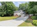 Exterior view of two-story home featuring a driveway, garage and a well-maintained front lawn with landscaping at 404 Sw Maynard Rd, Cary, NC 27511