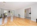 Bright living room with hardwood floors, large windows, and a neutral color palette at 404 Sw Maynard Rd, Cary, NC 27511