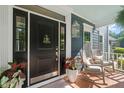 Inviting front entrance boasting rocking chairs, plants and a stylish black door with charming accents at 4151 Deep Wood Cir, Durham, NC 27707