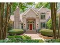 Charming brick house with a red front door framed by lush landscaping at 4905 Ivercroft Pl, Fuquay Varina, NC 27526