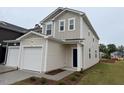 A modern townhome with a single-car garage and neutral siding stands on a well-maintained lawn at 507 Eastwood St, Durham, NC 27704