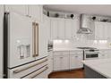 Modern kitchen showcases white cabinets, stainless steel appliances, and granite countertops for a sleek and stylish culinary space at 521 Morning Oaks Dr, Holly Springs, NC 27540