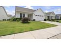 Inviting single-story home featuring a well-kept lawn and a convenient attached garage at 537 Bramble Ln, Clayton, NC 27527