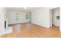 Bright living room showcasing hardwood floors and a decorative fireplace, offering a cozy and inviting atmosphere at 5429 Fortunes Ridge Dr, Durham, NC 27713