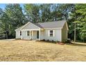 View of the side and front of a single-story home with light gray siding at 5500 Lake Wendell Rd, Zebulon, NC 27597