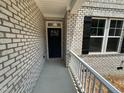 A welcoming front entryway showcasing the detailed brickwork and black door at 57 Blanton Ct, Lillington, NC 27546