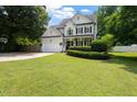 Charming two-story home features a manicured lawn, attached garage, and welcoming front porch at 5833 Dahlberg Dr, Raleigh, NC 27603