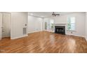 Inviting living room with a fireplace, wood floors, ceiling fan, and access to a patio at 6051 Epping Forest Dr, Raleigh, NC 27613