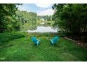 Inviting backyard with two chairs overlooking a serene lake view at 6205 Remington Lake Dr, Raleigh, NC 27616