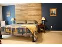Bedroom showcasing a wood-paneled accent wall and soft, neutral-toned bedding at 642 Collington Dr, Mebane, NC 27302