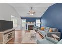 Bright living room featuring a fireplace, comfortable seating, and hardwood floors at 700 Mossburn Ct, Fuquay Varina, NC 27526