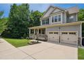 Beautifully landscaped two-story home featuring a covered front porch and an extended driveway leading to a two-car garage at 733 Bluffcreek Dr, Fuquay Varina, NC 27526
