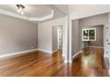 Bright and airy living room features hardwood floors, neutral walls, and a modern ceiling fixture with crown molding at 7414 Brandon Allen Ave, Raleigh, NC 27613