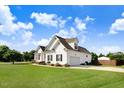 Well-maintained home showcasing lush green lawn, tidy landscaping, and a two-car garage at 8101 Claybrooke Ct, Willow Springs, NC 27592