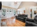 Inviting living room featuring hardwood floors, vaulted ceilings, and a decorative fireplace at 8101 Claybrooke Ct, Willow Springs, NC 27592