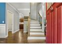 Elegant foyer with hardwood floors and a staircase, creating a warm and inviting entrance at 860 Cokesbury Rd, Fuquay Varina, NC 27526