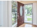 Bright foyer featuring hardwood floors, a decorative front door, and ample natural light at 102 Duxbury Dr, Cary, NC 27513