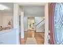 Open foyer showcasing hardwood floors, a staircase, and views into the dining and living areas at 102 Duxbury Dr, Cary, NC 27513
