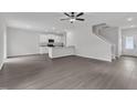 Bright, open-concept living space with hardwood floors connects to kitchen with granite counters at 104 Flue Ct, Oxford, NC 27565
