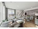 Spacious living area features sleek furnishings, decorative art, and seamless flow into the dining area at 1224 S Person St # 101, Raleigh, NC 27601