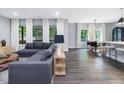 Bright living room with ample natural light, featuring a comfortable sectional sofa and open-concept design at 128 Chapel Run Way, Chapel Hill, NC 27517