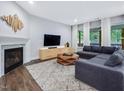 Cozy living room with fireplace, decorative wall art, and comfortable sectional sofa, perfect for relaxation at 128 Chapel Run Way, Chapel Hill, NC 27517