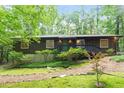 Exterior of a cozy home featuring well-maintained landscaping and a wood-sided facade at 1403 Meadow Ln, Chapel Hill, NC 27516