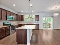 Open kitchen featuring a granite island, stainless steel appliances, and sliding door to a deck at 1434 Salem Dr, Apex, NC 27502