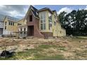 New construction home with large windows and a brick facade under construction in a spacious lot at 1531 Salem Church Rd, Apex, NC 27523