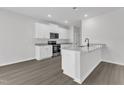 Modern kitchen island features stainless steel appliances and granite countertops at 205 Benton Dr, Oxford, NC 27565