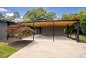 Spacious covered parking featuring a wood ceiling and concrete driveway at 2129 Ridge Rd, Raleigh, NC 27607